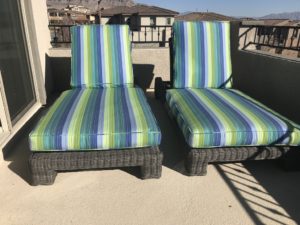 two blue and green outdoor lounge chairs